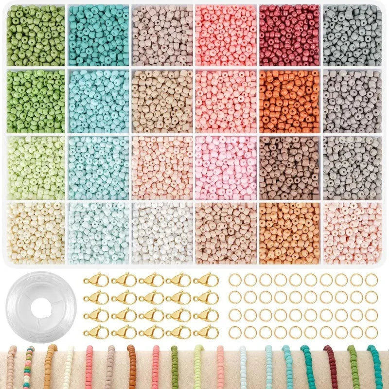 Organized tray of colorful beads with string, gold clasps, and jump rings for jewelry making